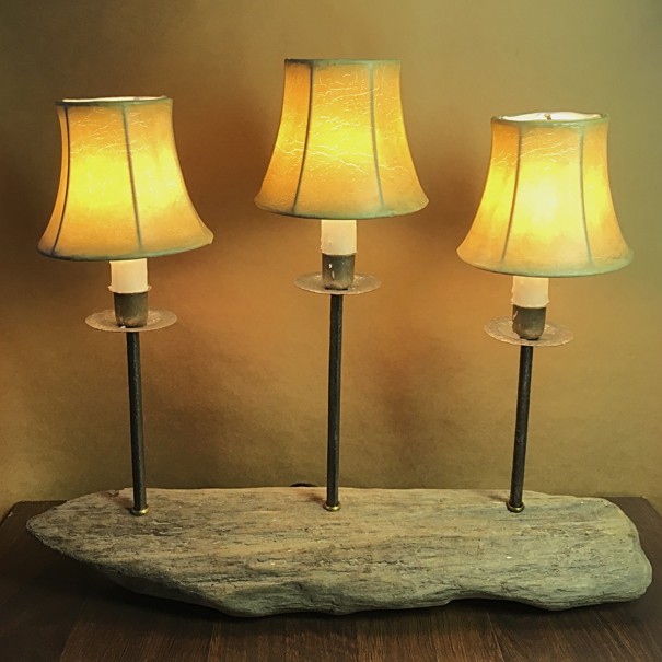 A custom made table lamp made from a driftwood log and salvaged iron at The Lamp Repair Shop in South Portland, Maine.