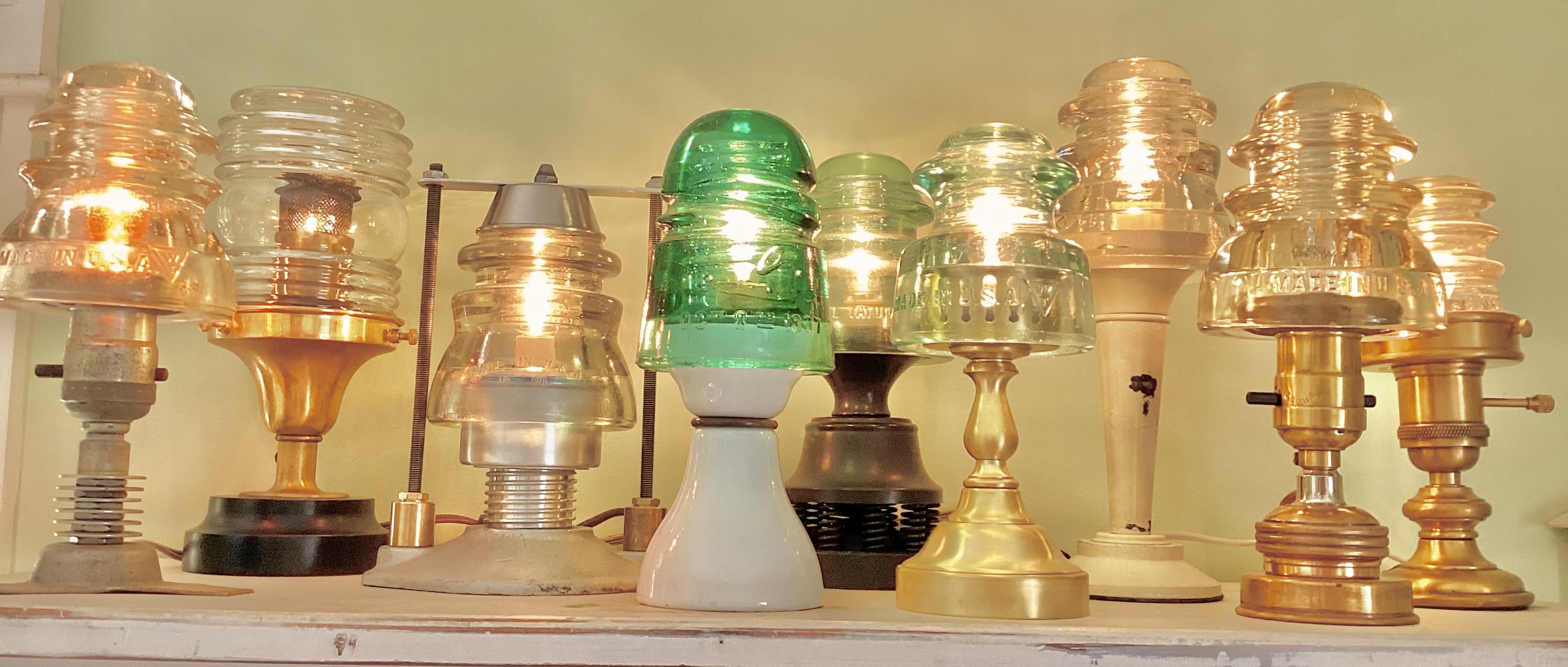 An array of one of a kind night lights made at The Lamp Repair Shop and Salvage Maine.